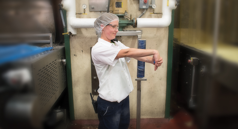Employee performing wrist stretch in an industrial setting
